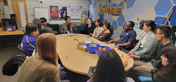 Alondra Nelson meets with students around a large table at the Tech Policy Lab office.